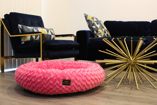 Pink round nest dog bed in lifestyle setting, handmade in Los Angeles