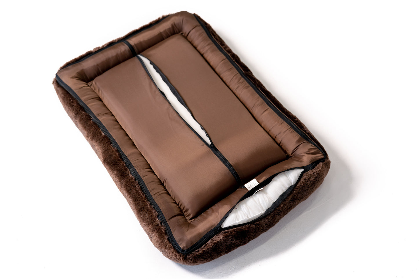 Dog crate mat in earthy tones showing machine washable removable cover